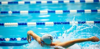 How do the results of swimming competitions impact the financial market?